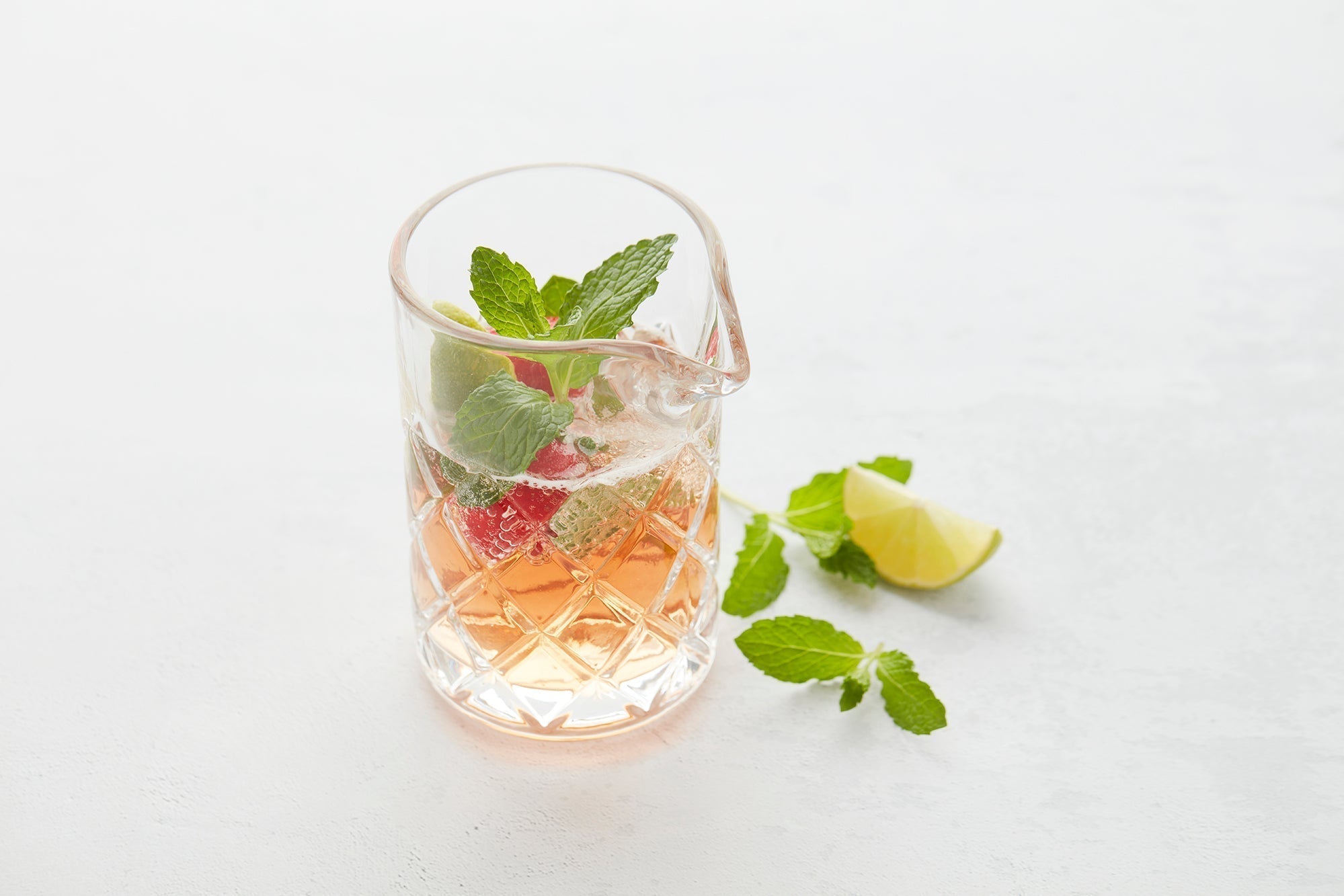 Refreshing cocktail with strawberry, lime & mint